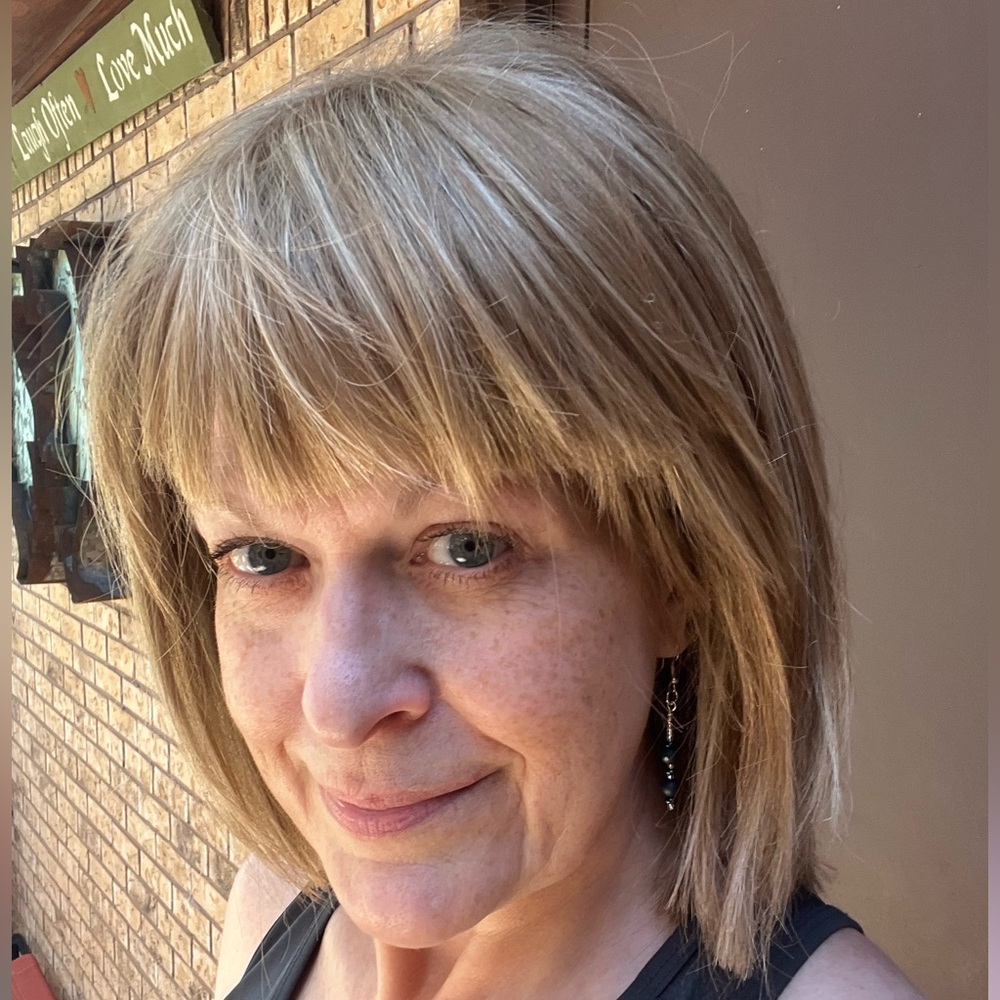 Noriko Jackson in Chai Cream synthetic wig, customized by pro hairdresser.